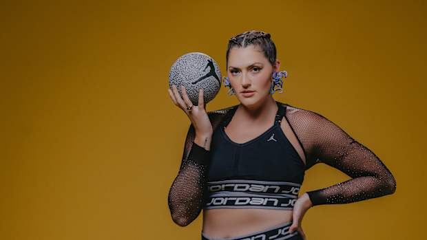 Stefanie Dolson models black and silver Jordan Brand basketball apparel.